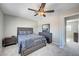 Bedroom with neutral decor, a bed, dresser and an open doorway that leads to another bedroom at , Henderson, NV 89014