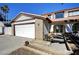 This two-story home has desert landscaping, a two-car garage and a covered entrance at , Henderson, NV 89014