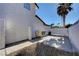 Side yard features a concrete patio area, stucco wall, and a low-maintenance rock landscape at , Henderson, NV 89014