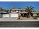 Traditional two-story home with a well-maintained yard, mature palm trees, and a two car garage at , Henderson, NV 89014