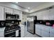 Updated kitchen with white cabinets, marble countertops, stainless appliances and tile backsplash at , Henderson, NV 89014