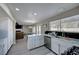 Open kitchen features white cabinets, stainless appliances, a view into the living room and marble countertops at , Henderson, NV 89014