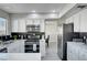 Modern kitchen features white cabinets, stainless steel appliances, gray floors and a black backsplash at , Henderson, NV 89014