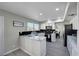 Bright kitchen featuring white cabinets, stainless steel appliances, gray floors and a black backsplash at , Henderson, NV 89014
