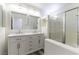 Modern bathroom featuring double sinks, white cabinets, and a glass-enclosed shower at 10162 Lemon Thyme St, Las Vegas, NV 89183