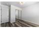 This bedroom features a mirrored closet, hardwood floor, and a modern ceiling light at 10162 Lemon Thyme St, Las Vegas, NV 89183