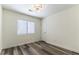 Bright bedroom with wood-look floors, window, and a modern ceiling light fixture at 10162 Lemon Thyme St, Las Vegas, NV 89183
