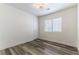 Bedroom featuring wood-look floors, window, and a modern ceiling light at 10162 Lemon Thyme St, Las Vegas, NV 89183