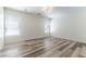 Bright bedroom with two windows, wood-look floors and modern ceiling light at 10162 Lemon Thyme St, Las Vegas, NV 89183