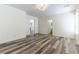 Bedroom featuring wood-look floors, white walls, and doors leading to other rooms at 10162 Lemon Thyme St, Las Vegas, NV 89183