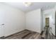 Bedroom featuring wood-look floors and doors leading to the bathroom and other rooms at 10162 Lemon Thyme St, Las Vegas, NV 89183