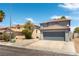 Two-story home with red tile roof and two-car garage in a neighborhood with desert landscaping at 10162 Lemon Thyme St, Las Vegas, NV 89183