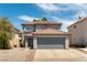 Two-story home featuring a red tile roof, two-car garage, neutral stucco, and low-maintenance desert landscaping at 10162 Lemon Thyme St, Las Vegas, NV 89183