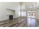 Living room with high ceilings, fireplace, and sliding glass door for outdoor access at 10162 Lemon Thyme St, Las Vegas, NV 89183