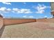 Fully fenced backyard with gravel and brick patio offers privacy and low-maintenance appeal at 10345 Zebra Swallowtail St, Las Vegas, NV 89141