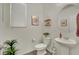 Well-lit half bath with a pedestal sink and stylish decor at 10345 Zebra Swallowtail St, Las Vegas, NV 89141