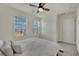 This carpeted bedroom has a ceiling fan, a closet with sliding doors and a window bringing in natural light at 10345 Zebra Swallowtail St, Las Vegas, NV 89141