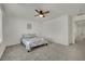 Cozy bedroom featuring soft gray carpet, a ceiling fan, and neutral decor for a comfortable and relaxing atmosphere at 10345 Zebra Swallowtail St, Las Vegas, NV 89141