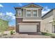 Charming two-story home with stone accents and a brick driveway at 10345 Zebra Swallowtail St, Las Vegas, NV 89141