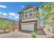 Charming two-story home with stone accents and a brick driveway at 10345 Zebra Swallowtail St, Las Vegas, NV 89141