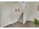 Bright foyer with staircase and neutral tile flooring at 10345 Zebra Swallowtail St, Las Vegas, NV 89141