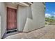 Covered entryway featuring a dark wood front door and brick pavers at 10345 Zebra Swallowtail St, Las Vegas, NV 89141