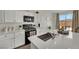 Bright kitchen with quartz countertops, island, and stainless steel appliances at 10345 Zebra Swallowtail St, Las Vegas, NV 89141