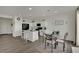 Well-lit kitchen with white cabinets, stainless steel appliances, and adjacent dining area at 10345 Zebra Swallowtail St, Las Vegas, NV 89141