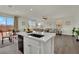 Bright kitchen with quartz countertops, island, and stainless steel appliances at 10345 Zebra Swallowtail St, Las Vegas, NV 89141
