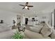 Open-concept living room and kitchen feature modern finishes and a ceiling fan at 10345 Zebra Swallowtail St, Las Vegas, NV 89141