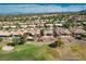 Aerial view shows a backyard with landscaping and patio, in a community with golf course and trees at 10504 Button Willow Dr, Las Vegas, NV 89134