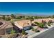 Expansive aerial view features a home with a tile roof, well-maintained landscaping, and picturesque mountain views at 10504 Button Willow Dr, Las Vegas, NV 89134