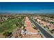 An aerial view of a lush neighborhood with palm trees, a golf course, and mature landscaping at 10504 Button Willow Dr, Las Vegas, NV 89134