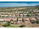 An aerial view reveals a community featuring palm trees, vibrant landscaping, and a backyard pool at 10504 Button Willow Dr, Las Vegas, NV 89134