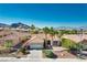 Breathtaking aerial view showcases the house, lush landscaping, surrounding neighborhood, and mountains in the background at 10504 Button Willow Dr, Las Vegas, NV 89134