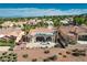 An aerial view featuring a landscaped backyard with desert plants, palm trees, and patio furniture at 10504 Button Willow Dr, Las Vegas, NV 89134