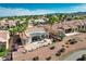 An elevated perspective reveals a property's landscaped backyard, a patio with furniture, and palm trees at 10504 Button Willow Dr, Las Vegas, NV 89134