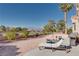 Beautiful backyard oasis with a lounge chair and landscaped surroundings overlooking a golf course at 10504 Button Willow Dr, Las Vegas, NV 89134