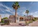 The home features a beautiful backyard with desert landscaping, lush flowering bushes, and a covered patio at 10504 Button Willow Dr, Las Vegas, NV 89134