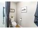 Clean half bathroom with a white toilet and simple décor, adjacent to the shower at 10504 Button Willow Dr, Las Vegas, NV 89134