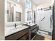 Modern bathroom showcases dual vanities, sleek black fixtures, and a glass-enclosed shower at 10504 Button Willow Dr, Las Vegas, NV 89134