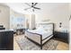 Bright bedroom with a comfortable bed, desk area, and ample natural light from bay windows at 10504 Button Willow Dr, Las Vegas, NV 89134
