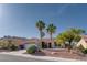 Inviting home features a manicured lawn, mature palm trees, and a tile roof, creating a warm and welcoming atmosphere at 10504 Button Willow Dr, Las Vegas, NV 89134
