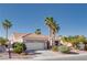 Inviting home features a manicured lawn, mature palm trees, and a tile roof, creating a warm and welcoming atmosphere at 10504 Button Willow Dr, Las Vegas, NV 89134