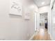 Inviting hallway features lovely wall decor and pristine hardwood floors leading into the room at 10504 Button Willow Dr, Las Vegas, NV 89134