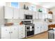 Bright kitchen boasts white cabinets, stainless steel appliances, and ample counter space at 10504 Button Willow Dr, Las Vegas, NV 89134