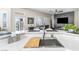 Modern kitchen featuring stainless steel sink and a view into the living room at 10504 Button Willow Dr, Las Vegas, NV 89134