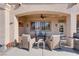 Inviting covered patio featuring comfortable seating and a cozy fire pit, perfect for outdoor relaxation at 10504 Button Willow Dr, Las Vegas, NV 89134