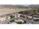 Aerial view of a quiet neighborhood showcases beautiful houses, desert, and mountain views at 1079 Oak Shade Ln, Henderson, NV 89015