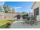 Backyard patio with seating, BBQ grill, and lush grass, great for outdoor dining at 1079 Oak Shade Ln, Henderson, NV 89015